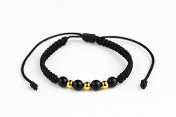 Pulsera negra de hilo tejido con cuentas negras y doradas