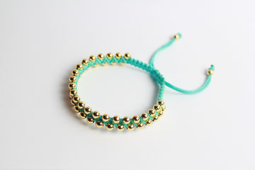 Pulsera Hilo Azul con Cuentas Doradas