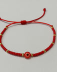 Pulsera de hilo ojo turco con cuentas doradas