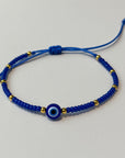 Pulsera de hilo ojo turco con cuentas doradas