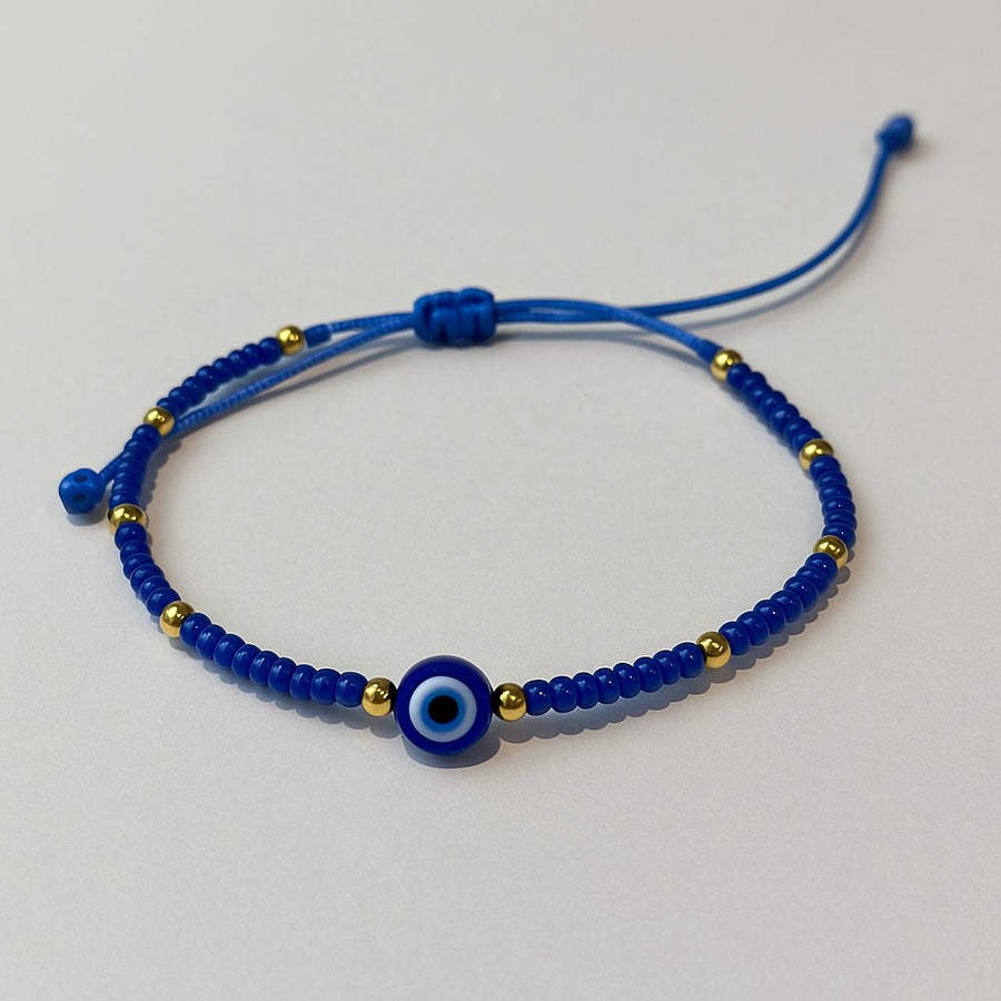 Pulsera de hilo ojo turco con cuentas doradas