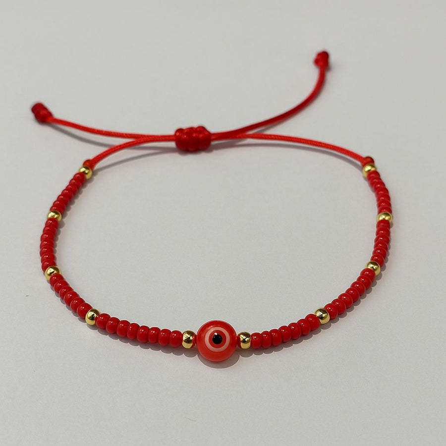Pulsera de hilo ojo turco con cuentas doradas